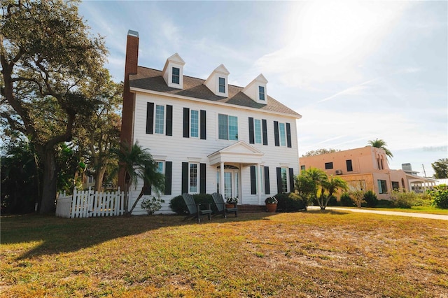 colonial inspired home with a front yard