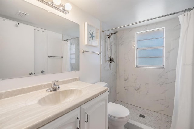 bathroom with vanity, curtained shower, and toilet