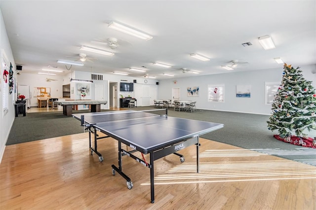 rec room featuring ceiling fan and light hardwood / wood-style floors