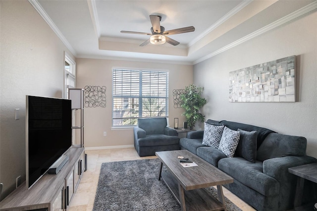 living room featuring a tray ceiling, crown molding, and ceiling fan