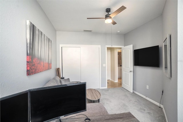 carpeted office featuring ceiling fan