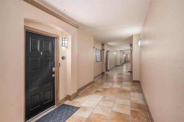 hall with light tile patterned floors