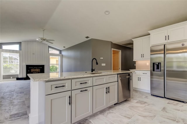 kitchen featuring white cabinets, ceiling fan, lofted ceiling, and stainless steel appliances