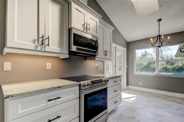 kitchen with light stone counters, stainless steel appliances, vaulted ceiling, a notable chandelier, and white cabinets