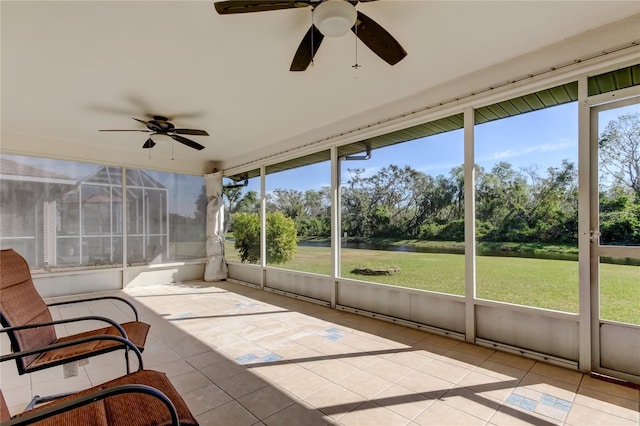 unfurnished sunroom featuring ceiling fan