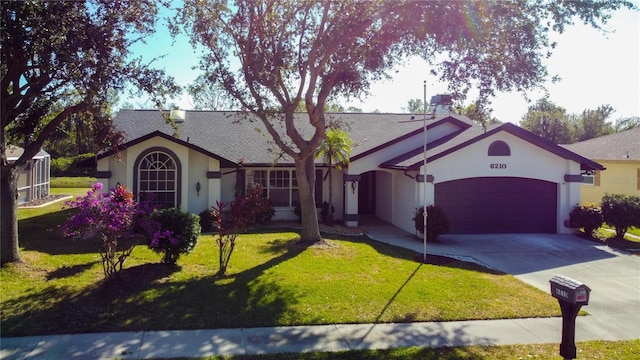 view of front of property with a front lawn and a garage