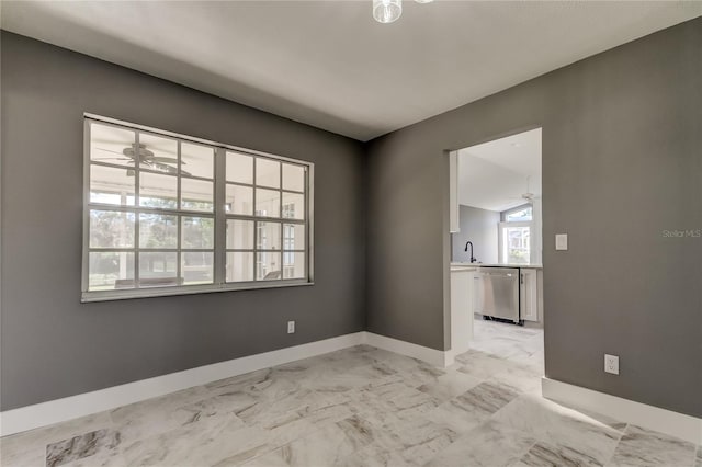 spare room featuring ceiling fan and sink