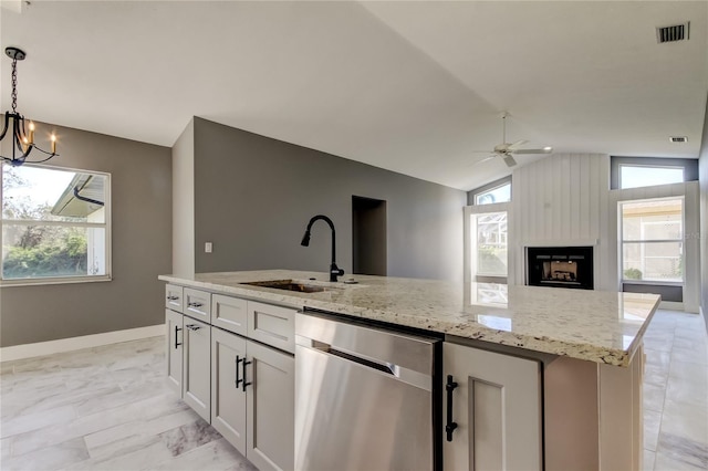 kitchen featuring white cabinets, vaulted ceiling, sink, dishwasher, and hanging light fixtures