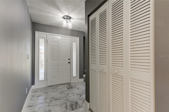 entryway featuring a textured ceiling