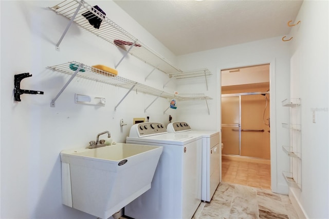 laundry area featuring washer and clothes dryer and sink