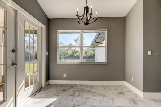 unfurnished dining area featuring an inviting chandelier