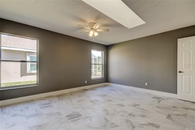 empty room featuring ceiling fan and a textured ceiling