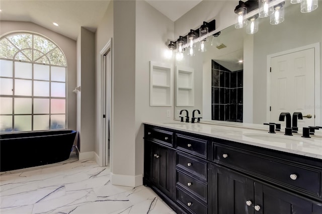 bathroom with vanity, a bathtub, and lofted ceiling