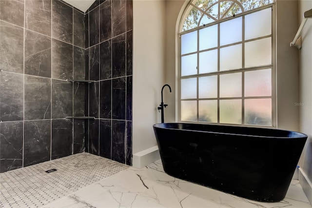 bathroom with a tub to relax in