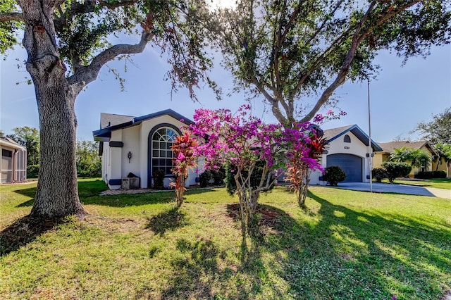 single story home featuring a garage and a front lawn