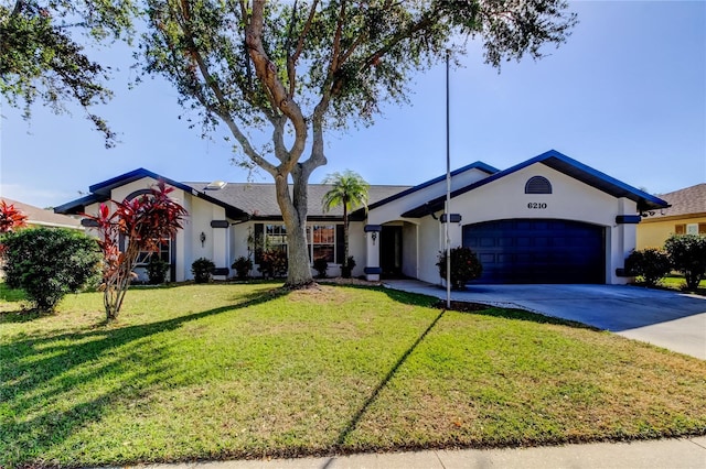 ranch-style home with a front yard and a garage