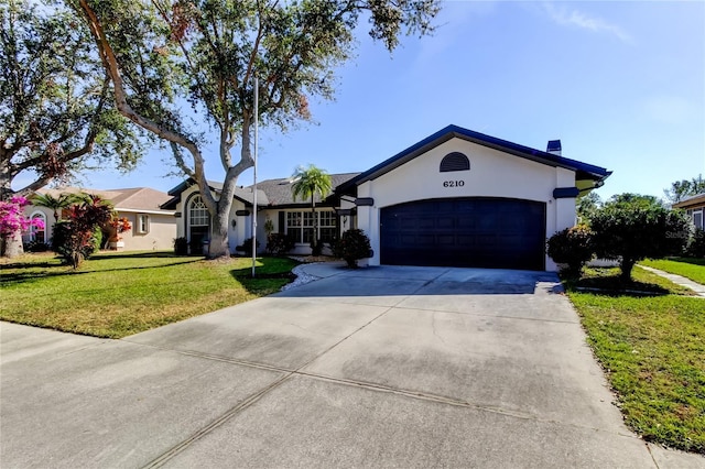 ranch-style home with a front lawn and a garage