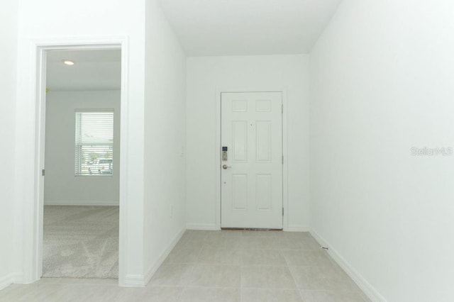 foyer entrance with light carpet