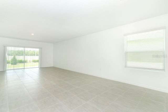 unfurnished room featuring light tile patterned floors