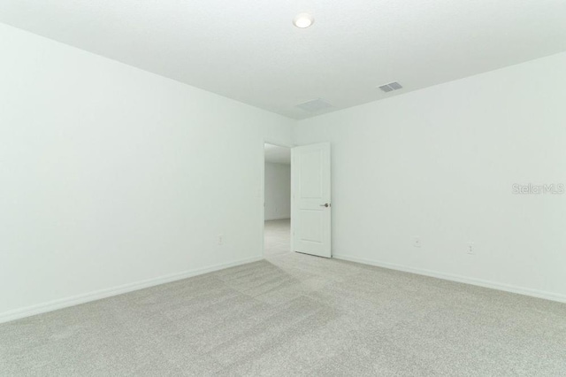 empty room featuring light carpet