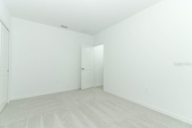 empty room with light colored carpet