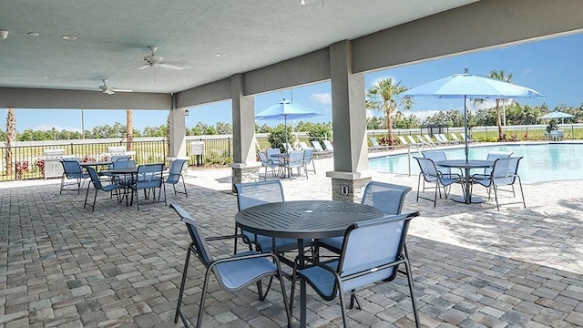 view of patio / terrace featuring ceiling fan and a community pool