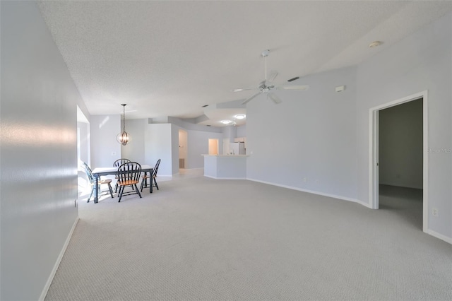 interior space with ceiling fan and light colored carpet