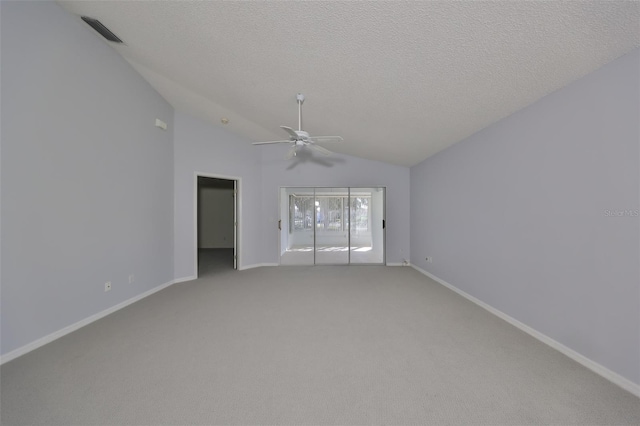 unfurnished room featuring carpet, a textured ceiling, vaulted ceiling, and ceiling fan