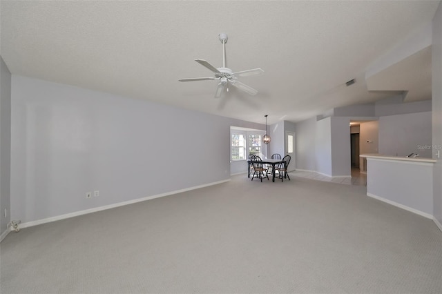 carpeted empty room with ceiling fan and a textured ceiling