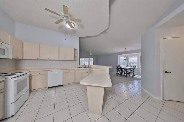 kitchen featuring kitchen peninsula, light brown cabinetry, white appliances, vaulted ceiling, and sink