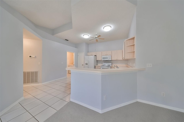 kitchen with kitchen peninsula, a textured ceiling, white appliances, and ceiling fan