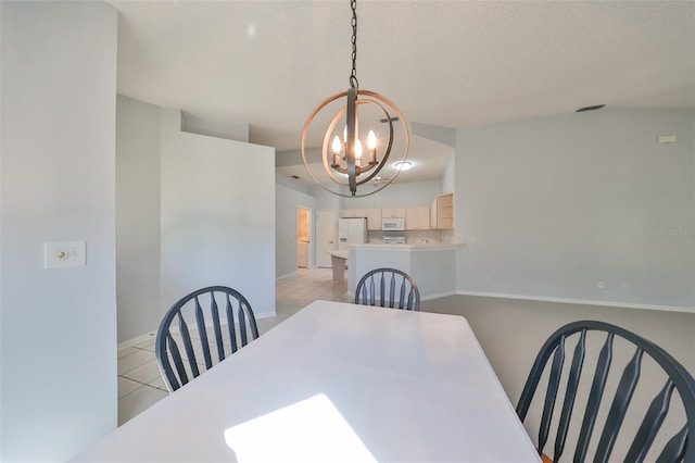 dining space with light tile patterned floors, a textured ceiling, an inviting chandelier, and lofted ceiling