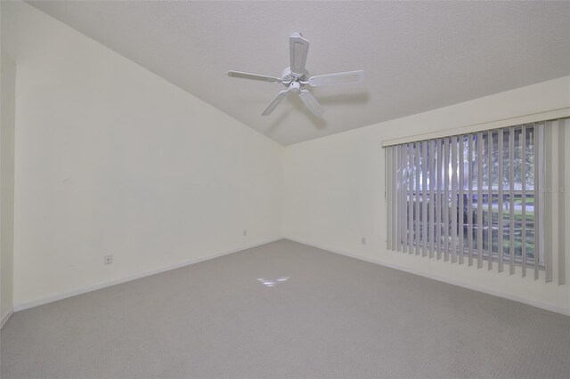 carpeted empty room with a textured ceiling and ceiling fan