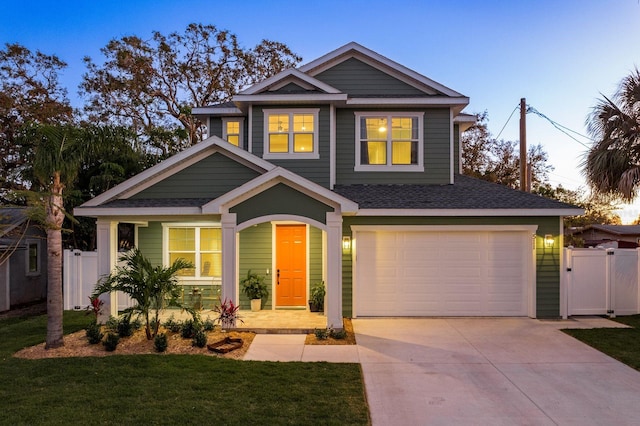 view of front of property with a yard and a garage