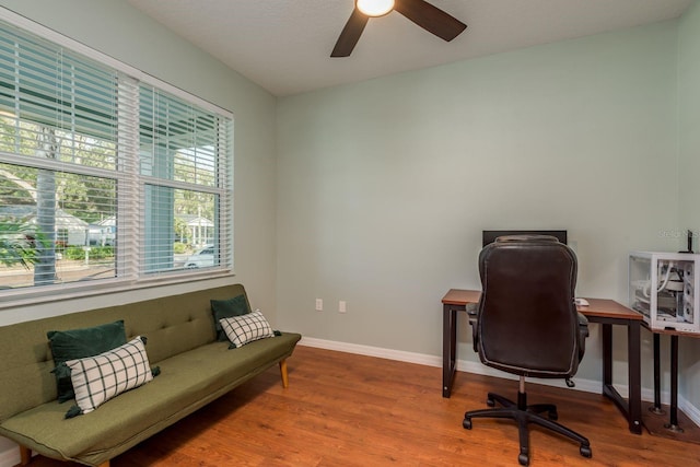 office with hardwood / wood-style floors and ceiling fan