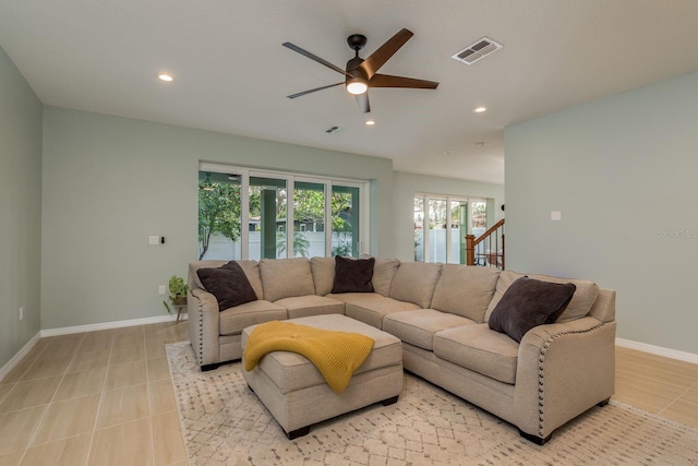 tiled living room featuring ceiling fan