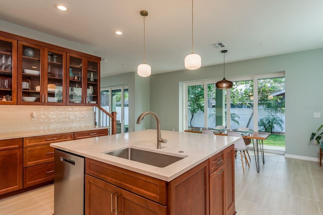 kitchen with pendant lighting, sink, dishwasher, a kitchen island with sink, and a wealth of natural light