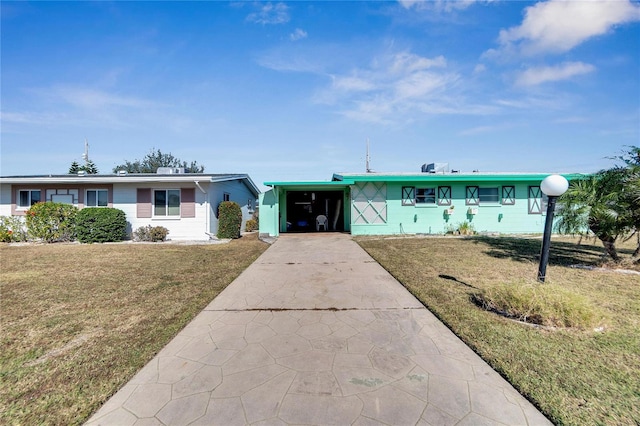 ranch-style home featuring a carport and a front lawn