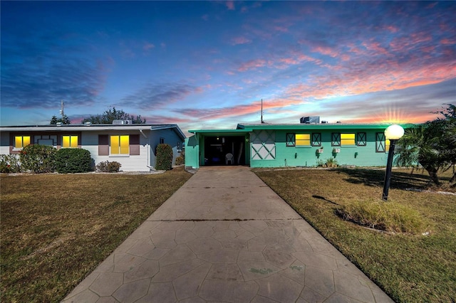 single story home with a yard and a carport