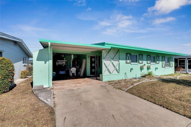 view of front of property with a front yard and a carport