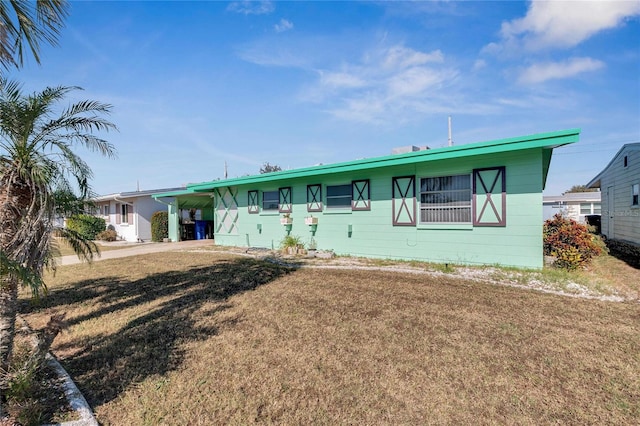 ranch-style house with a front lawn and a carport