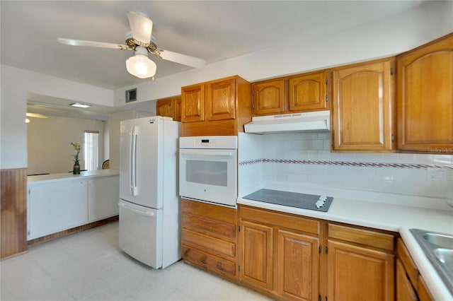 kitchen with backsplash, ceiling fan, and white appliances