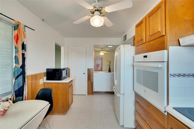 kitchen with light tile patterned floors, ceiling fan, and black appliances