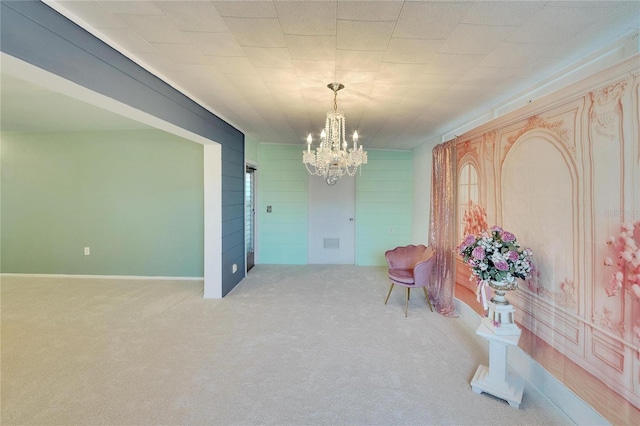 living area with carpet floors and a chandelier