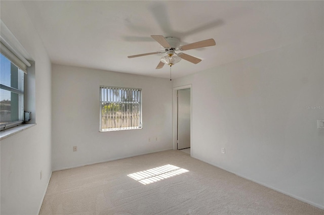 spare room featuring ceiling fan and light colored carpet