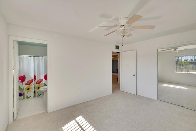 unfurnished bedroom with light carpet and ceiling fan