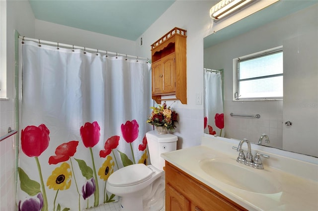 bathroom featuring vanity, a shower with curtain, tile patterned flooring, toilet, and tile walls