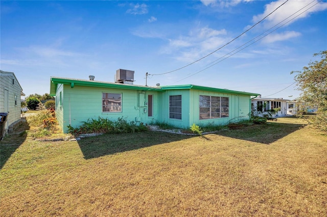 view of front facade with central AC unit and a front lawn