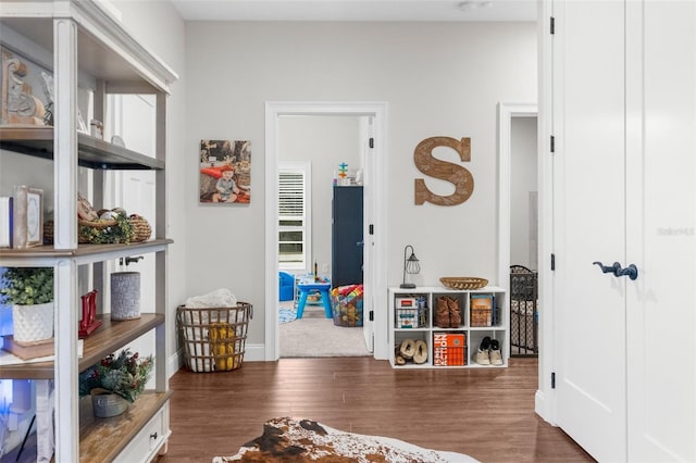 recreation room featuring wood finished floors and baseboards