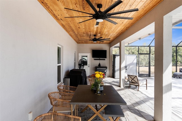 view of patio / terrace with a ceiling fan, outdoor dining space, a lanai, and a grill